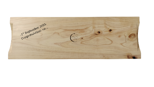 Wooden block with engraved text on a white background