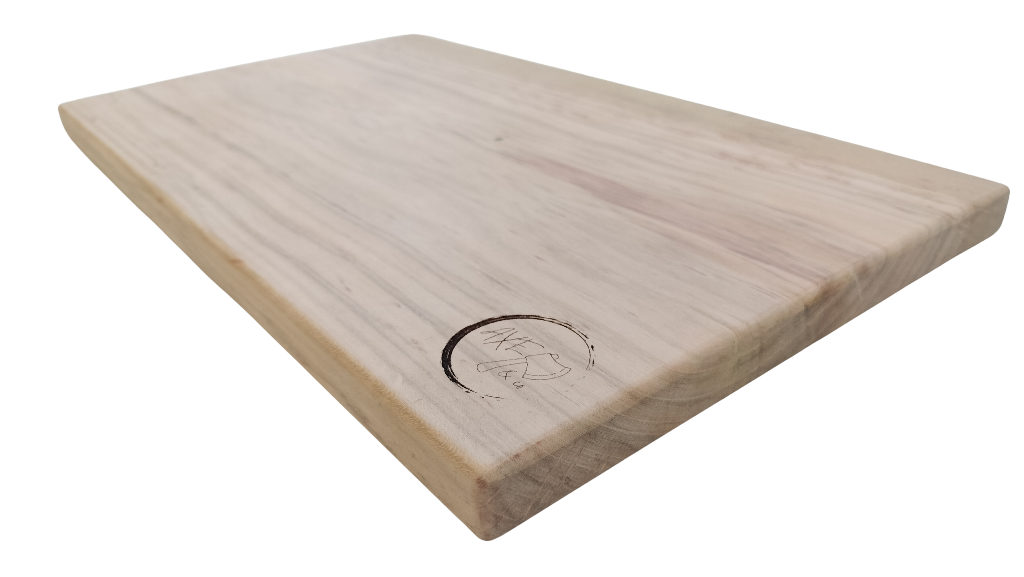 Wooden cutting board with engraved design on a white background